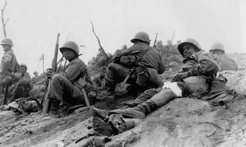 Korean War soldiers waiting on a hill. 